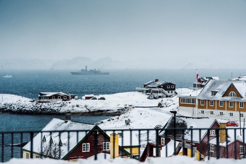 A ship off a snowy coast.