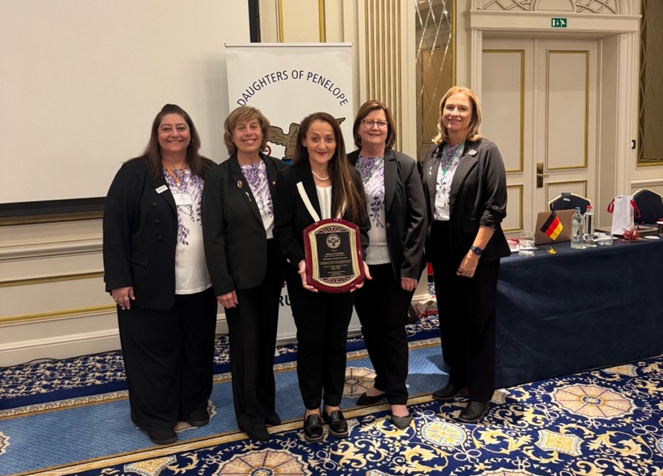Left to Right: Grand Treasurer Effie Kirkiles, Grand President Antoinette Marousis Zacharaides, Grand Vice President Gretchen Holtsinger, and Grand Secretary Patty Didik presenting the 2026 Daughters of Penelope Service Award to Region Governor of Europe and Australia Athanasia Vassiliadou in appreciation of her ten years of distinguished service and unselfish contribution as Region Governor of Europe and Australia.
