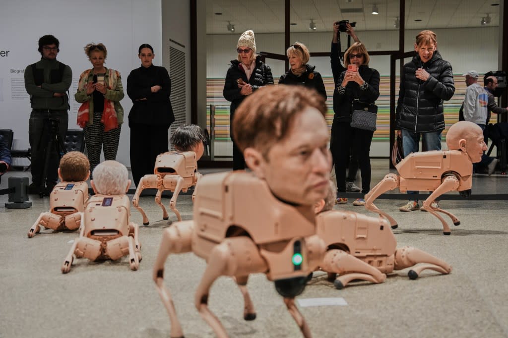 The dogs have silicone heads modeled after figures like Elon Musk and Jeff Bezos. AP