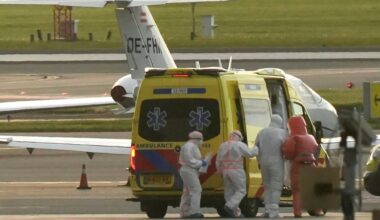 A person in a hazmat suit was escorted to an ambulance at Schiphol airport near Amsterdam on May 6, 2026