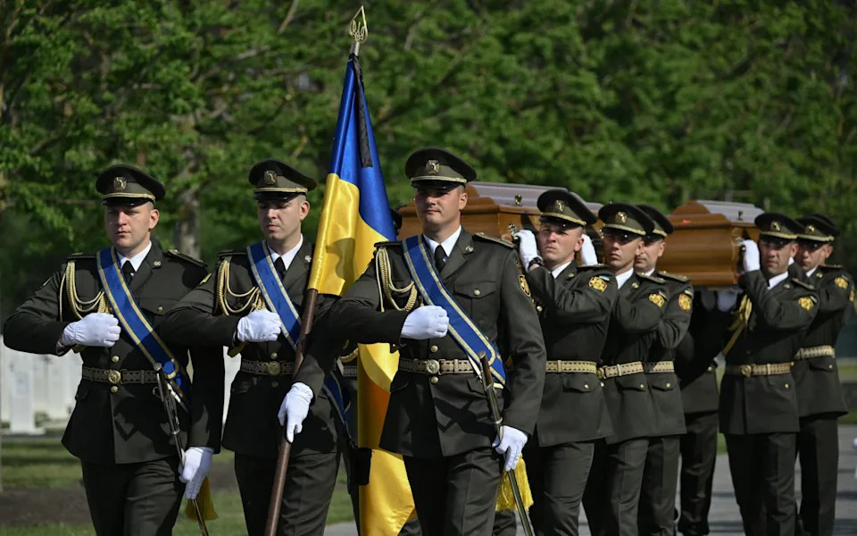 Ukrainian servicemen carry the coffin of Andriy Melnyk