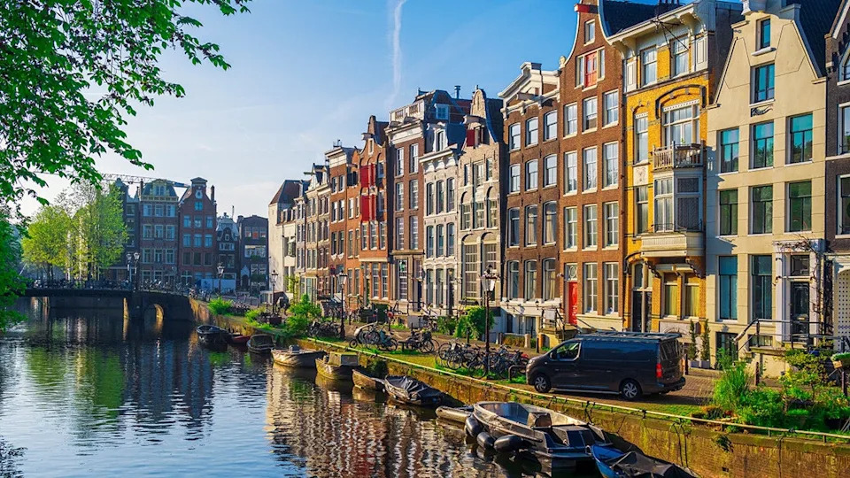 Canal houses and boats on the canal in downtown Amsterdam