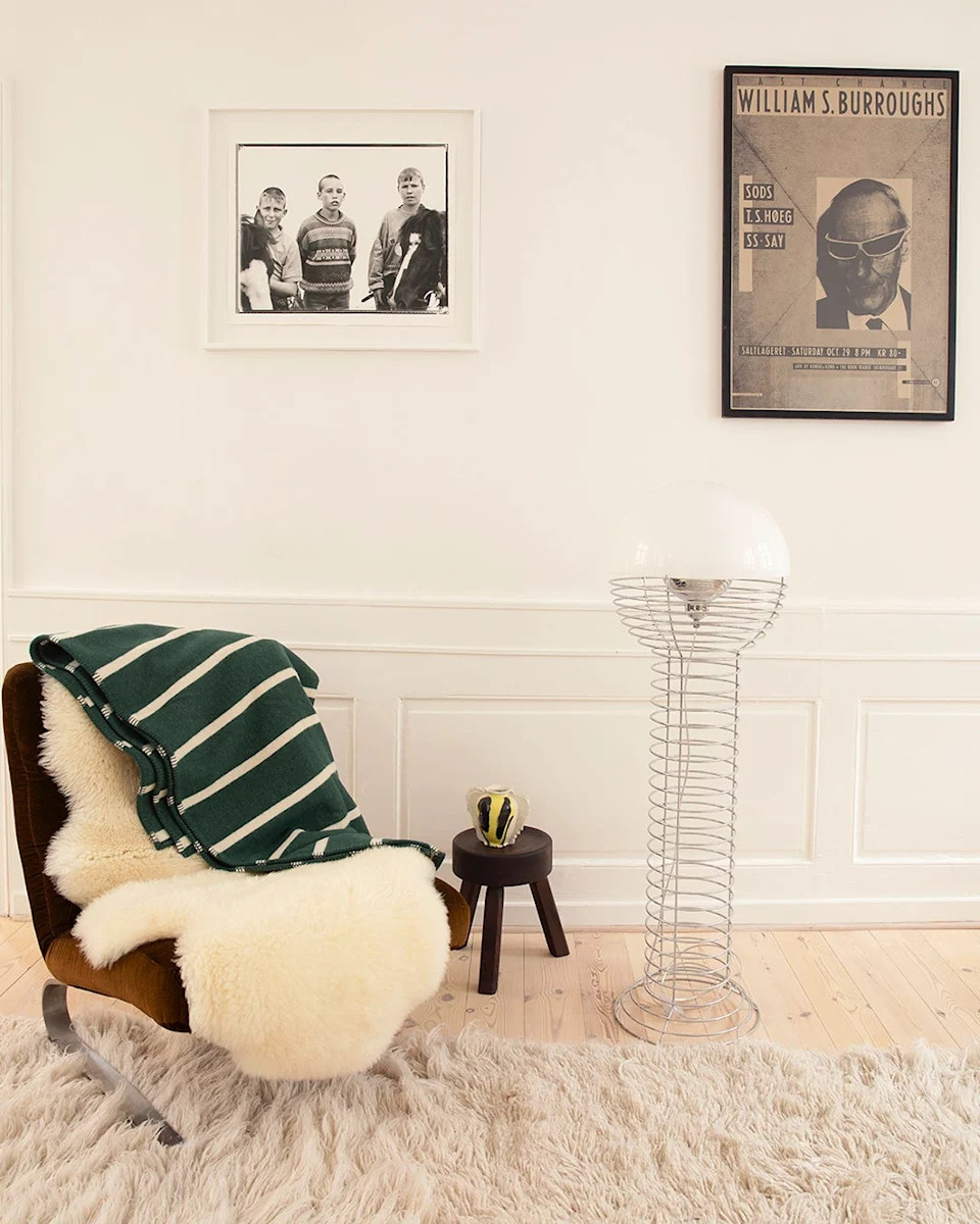 cozy interior featuring a modern chair decorative blanket and artwork