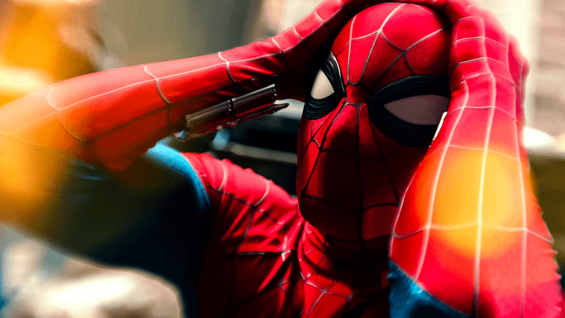 Spider-Man holding his head.