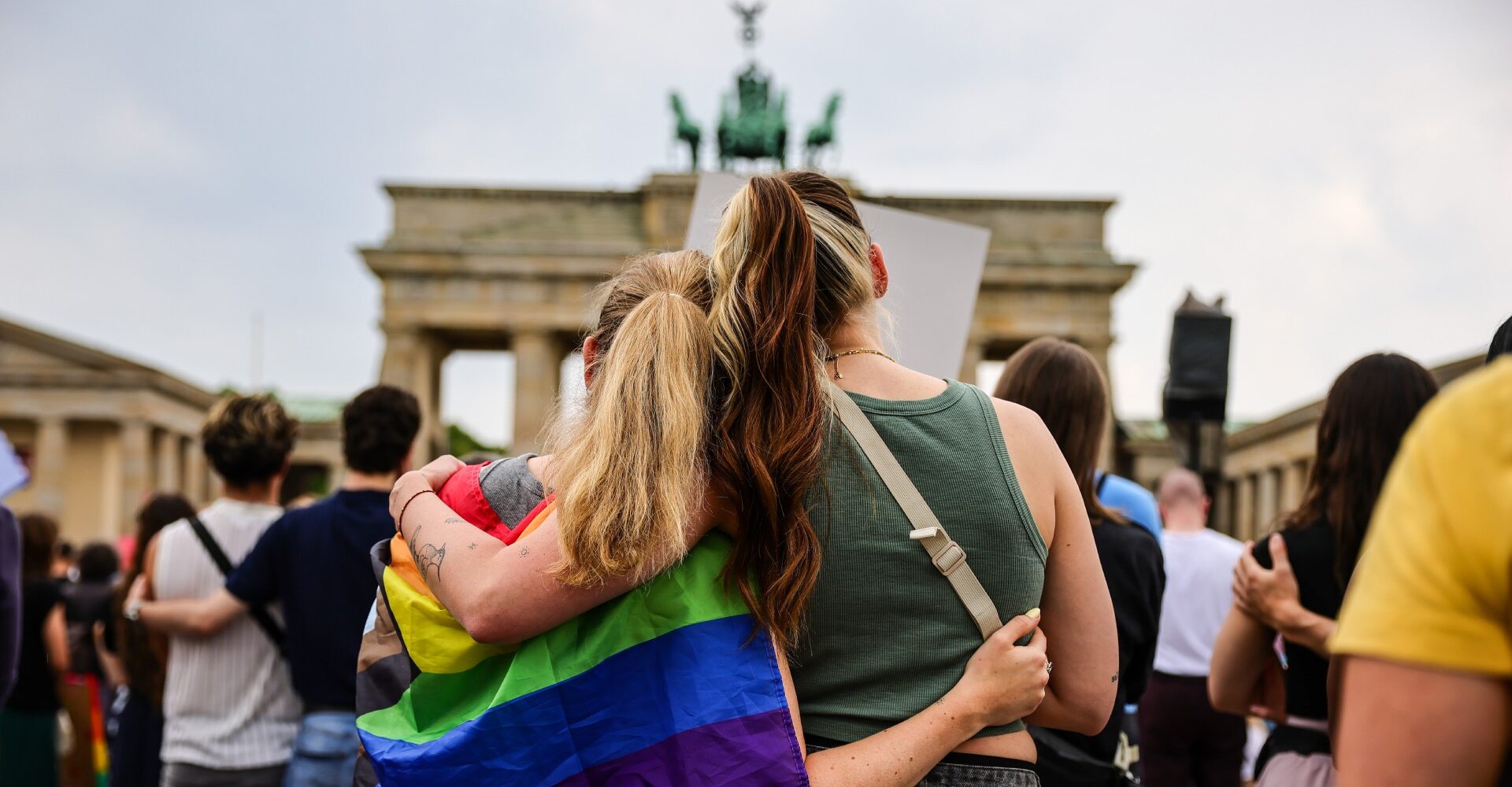 People gather at the Brandenburg Gate in a memorial of the Berlin pride attack