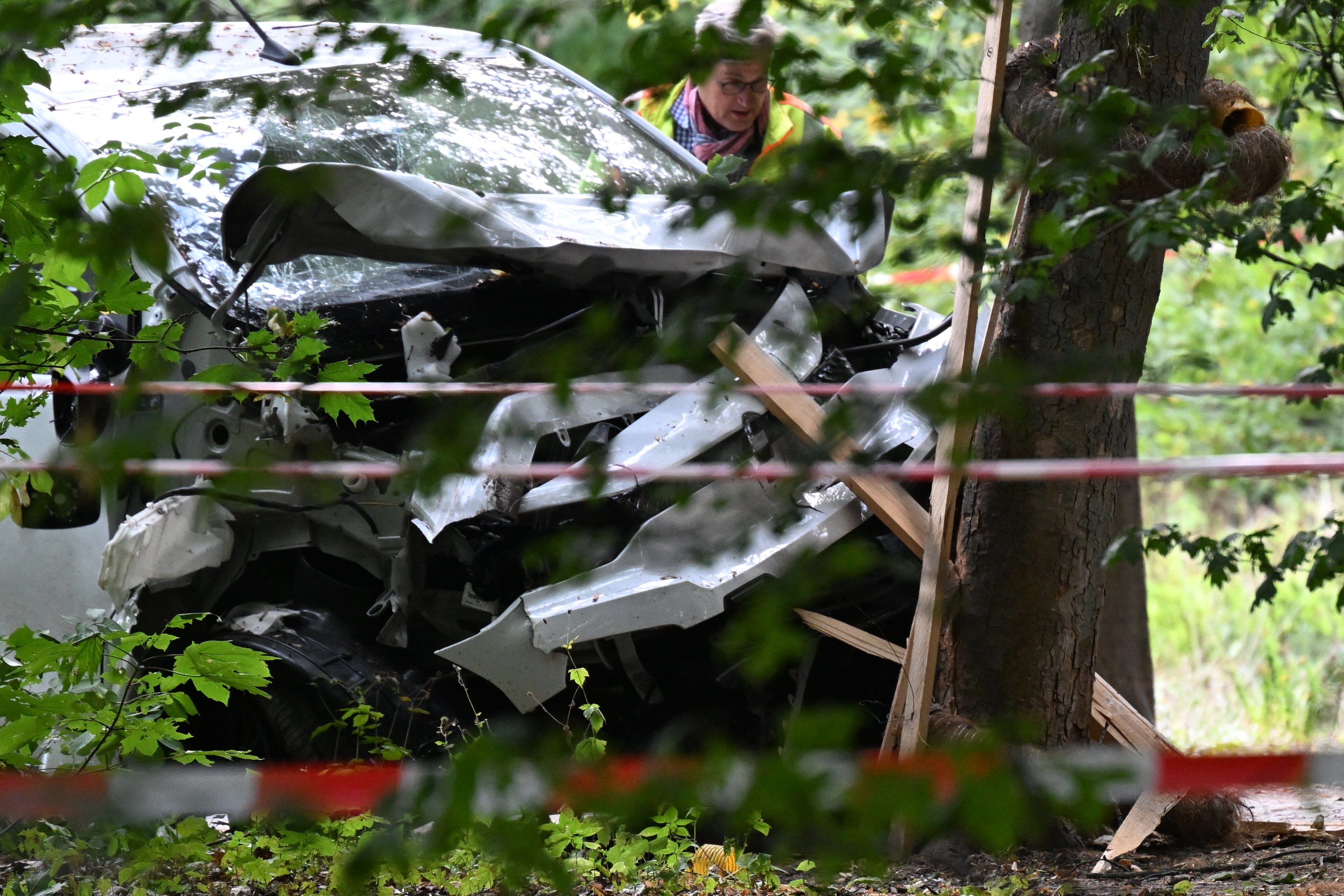 A police officer inspects a car that was allegedly driven into a crowd on the outskirts of the Christopher Street Day parade in Berlin