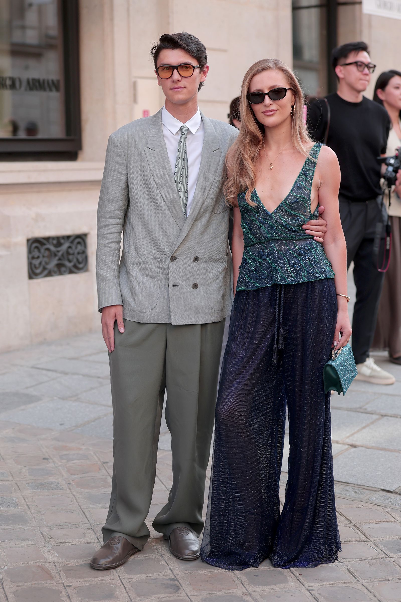 Image may contain Clothing Formal Wear Suit Blazer Coat Jacket Dress Adult Person People Pants and Photobombing