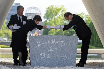 El alcalde de Hiroshima, Kazumi Matsui (derecha), coloca una lista con los nombres de víctimas de la bomba atómica en el cenotafio durante la ceremonia conmemorativa este miércoles. 
