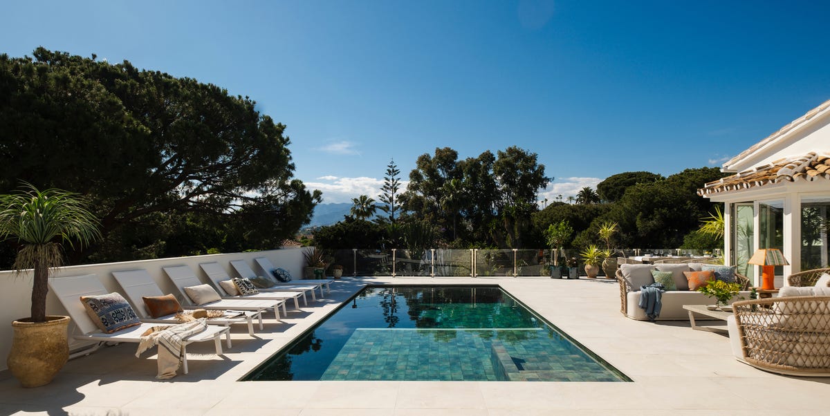 Una casa blanca en Málaga con una arquitectura tradicional y un interior de espacios abiertos decorados con estilo moderno y elegante