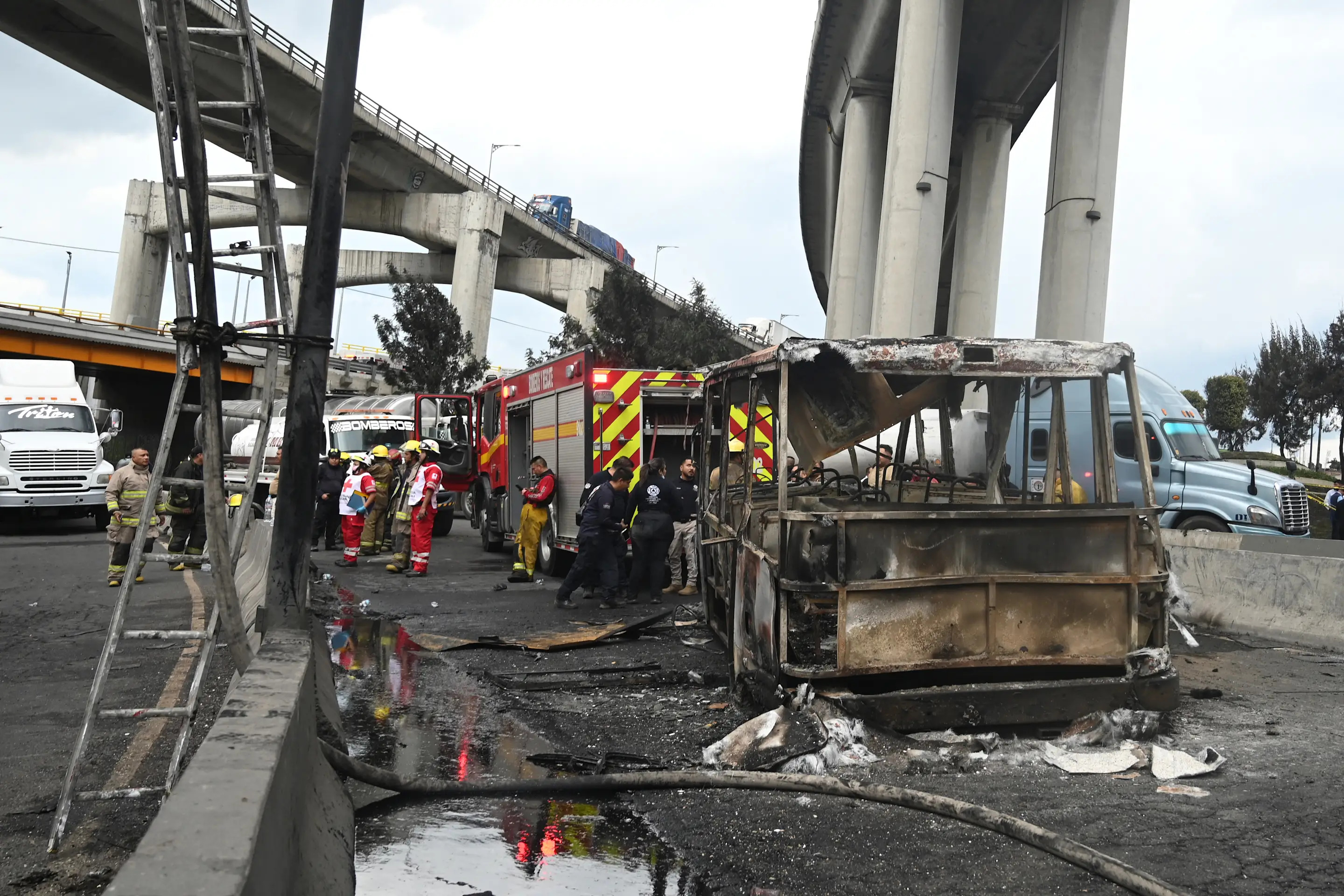 Mexican firefighters guard the area where a gas truck exploded in Mexico City on September 10, 2025. Nearly 60 people were wounded, 19 gravely, when a gas truck exploded in Mexico City on September 10, 2025, causing widespread damage, municipal officials said. (Photo by Valentina ALPIDE / AFP) (Photo by VALENTINA ALPIDE/AFP via Getty Images)          