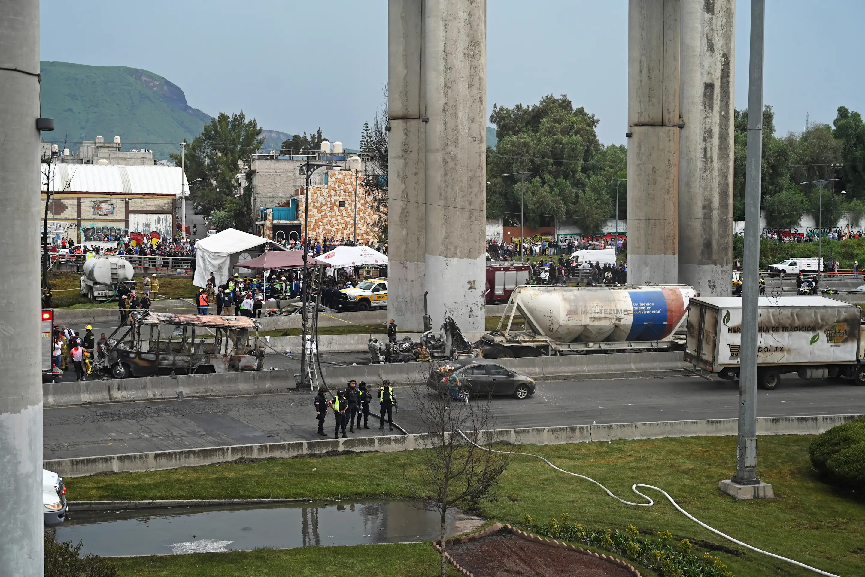 Mexican firefighters guard the area where a gas truck exploded in Mexico City on September 10, 2025. Nearly 60 people were wounded, 19 gravely, when a gas truck exploded in Mexico City on September 10, 2025, causing widespread damage, municipal officials said. (Photo by Valentina ALPIDE / AFP) (Photo by VALENTINA ALPIDE/AFP via Getty Images)          