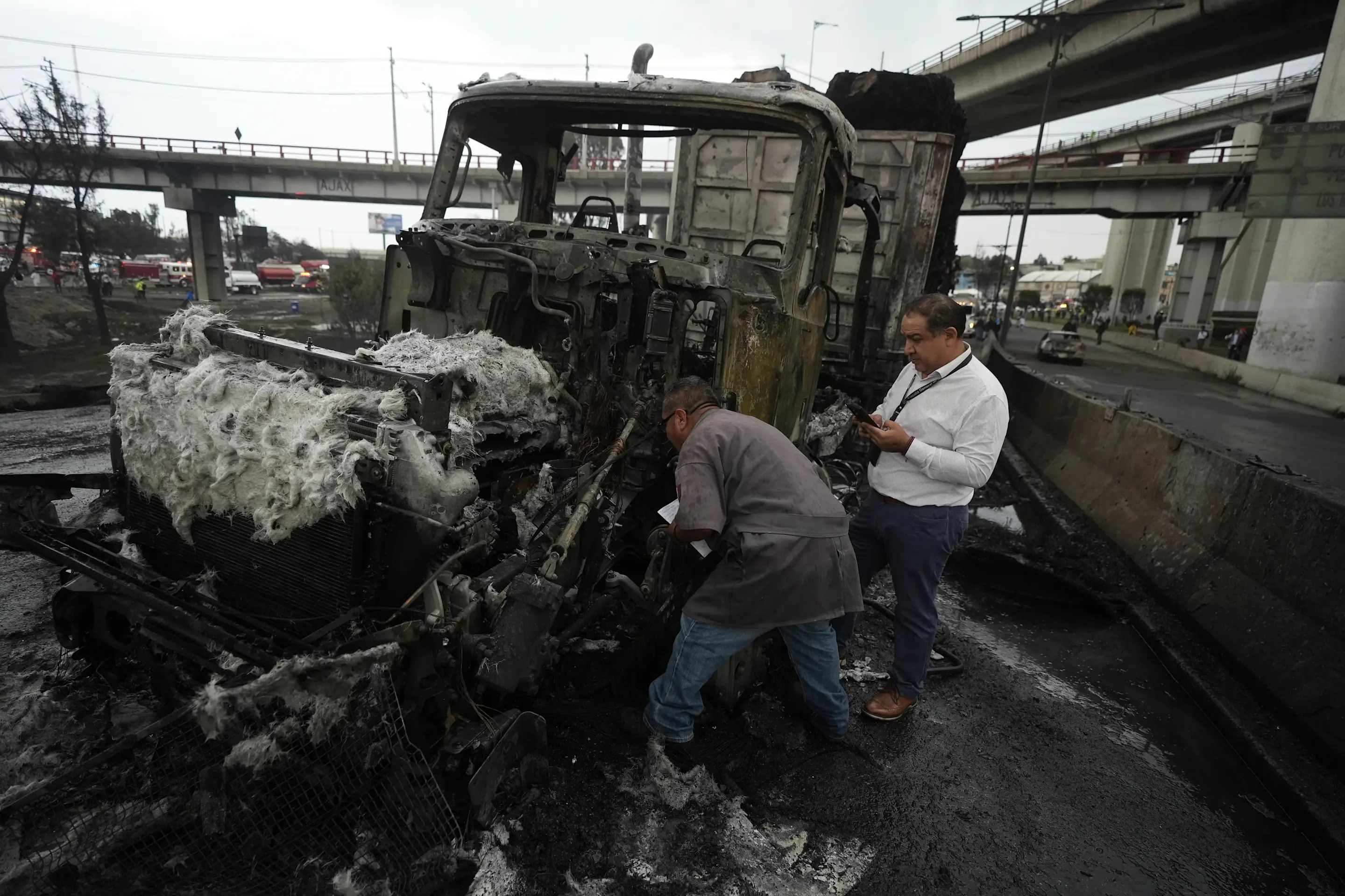 Investigators inspect burned cars after a gas tanker explosion in Mexico City, Wednesday, Sept. 10, 2025. (AP Photo/Fernando Llano)