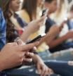 Close Up Of A Line Of High School Students Using Mobile Phones
