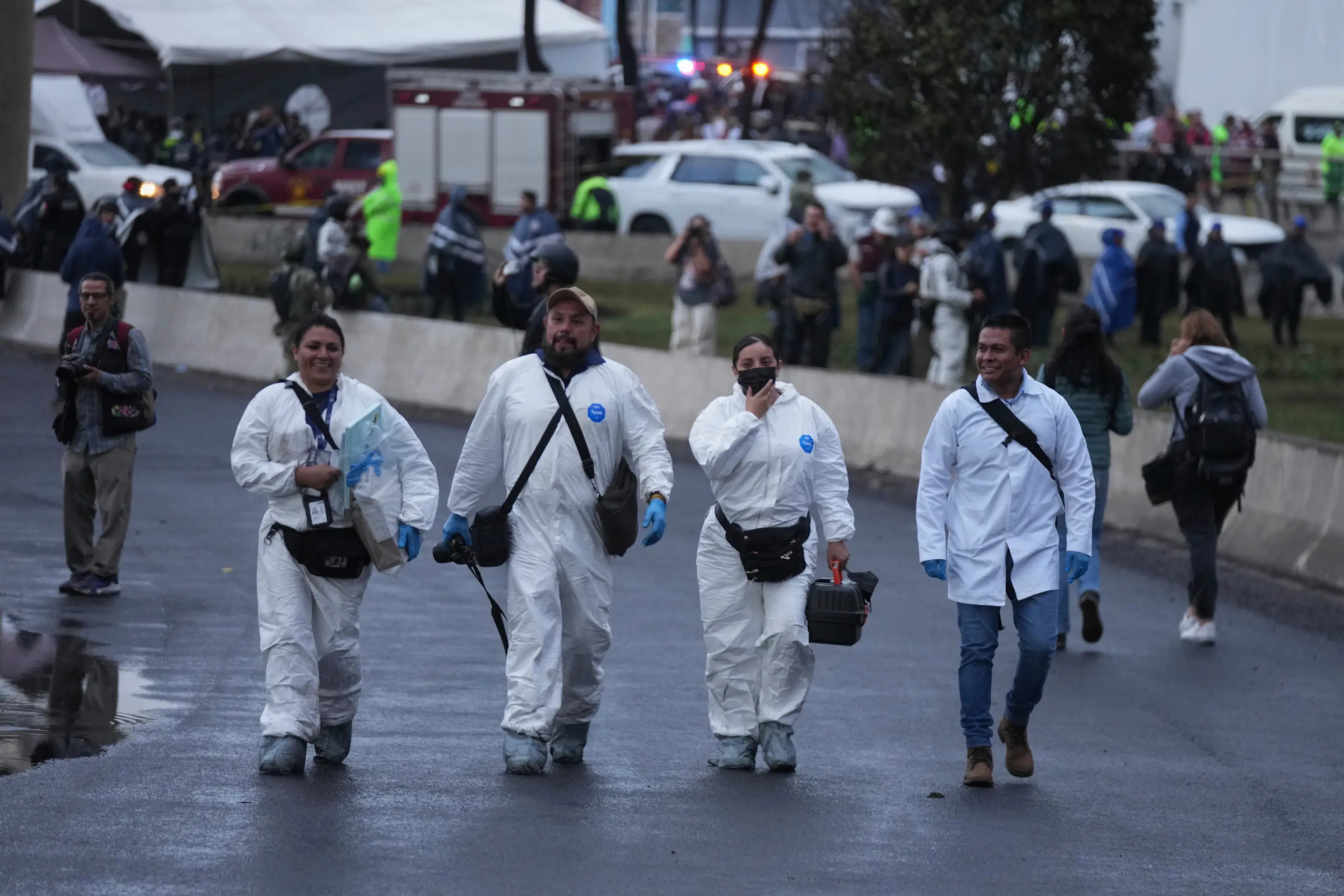 Forensic workers arrive at the scene after a gas tanker exploded under a highway underpass in Mexico City, Wednesday, Sept. 10, 2025. (AP Photo/Fernando Llano)
