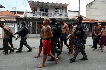 Members of the military police special unit detain suspected drug dealers during a police operation against drug trafficking at the favela do Penha, in Rio de Janeiro, Brazil October 28, 2025