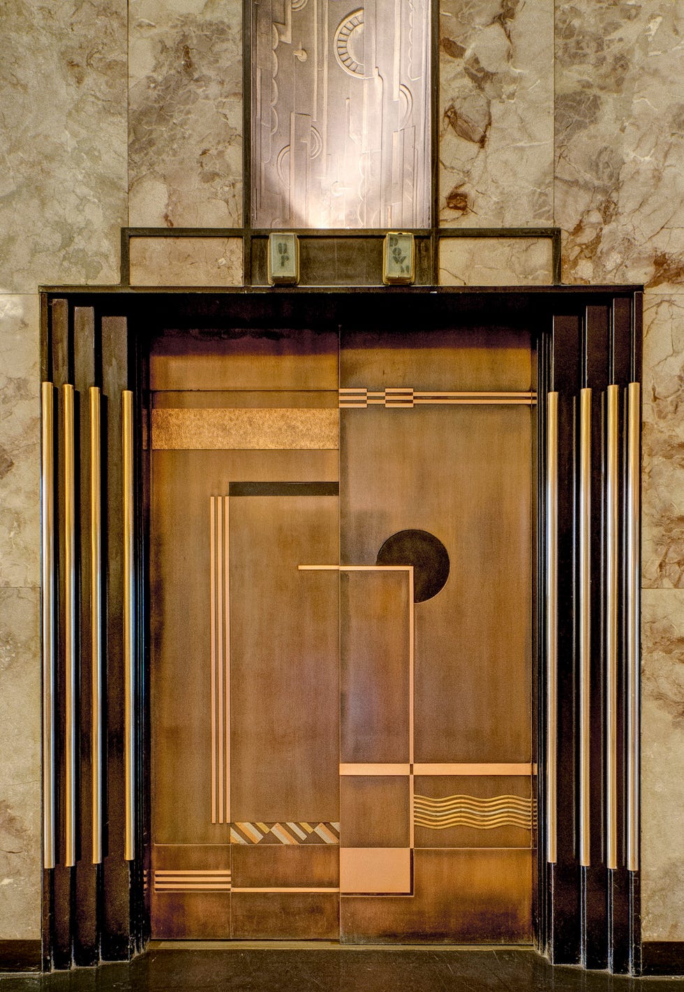 Elevator doors featuring an Art Deco design.