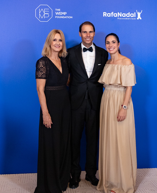 three people posing for a photo against a blue background three people posing for a photo against a blue background