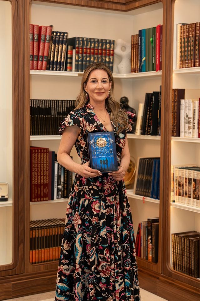 woman holding a book in a library setting with shelves full of books