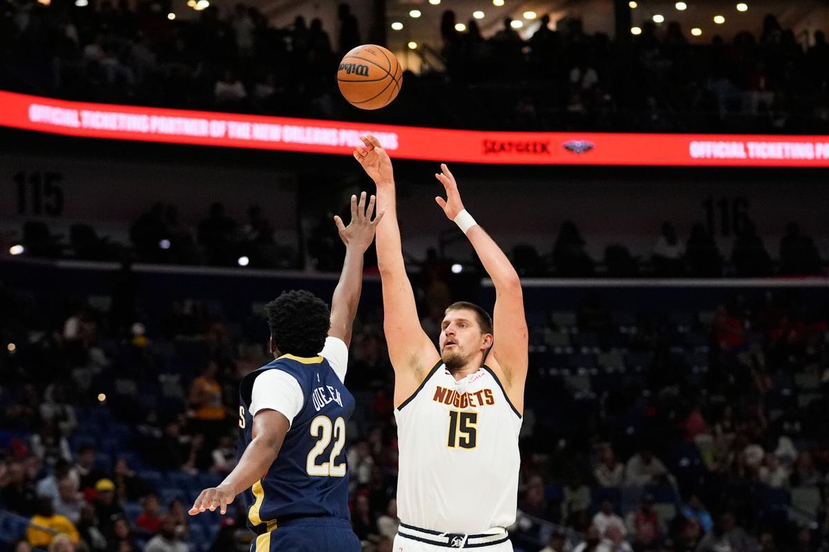 Denver Nuggets center Nikola Jokic (15) shoots over New Orleans Pelicans center Derik Queen (22) shoots against in the second half of an NBA basketball game, Wednesday, Nov. 19, 2025, in New Orleans. (AP Photo/Gerald Herbert)