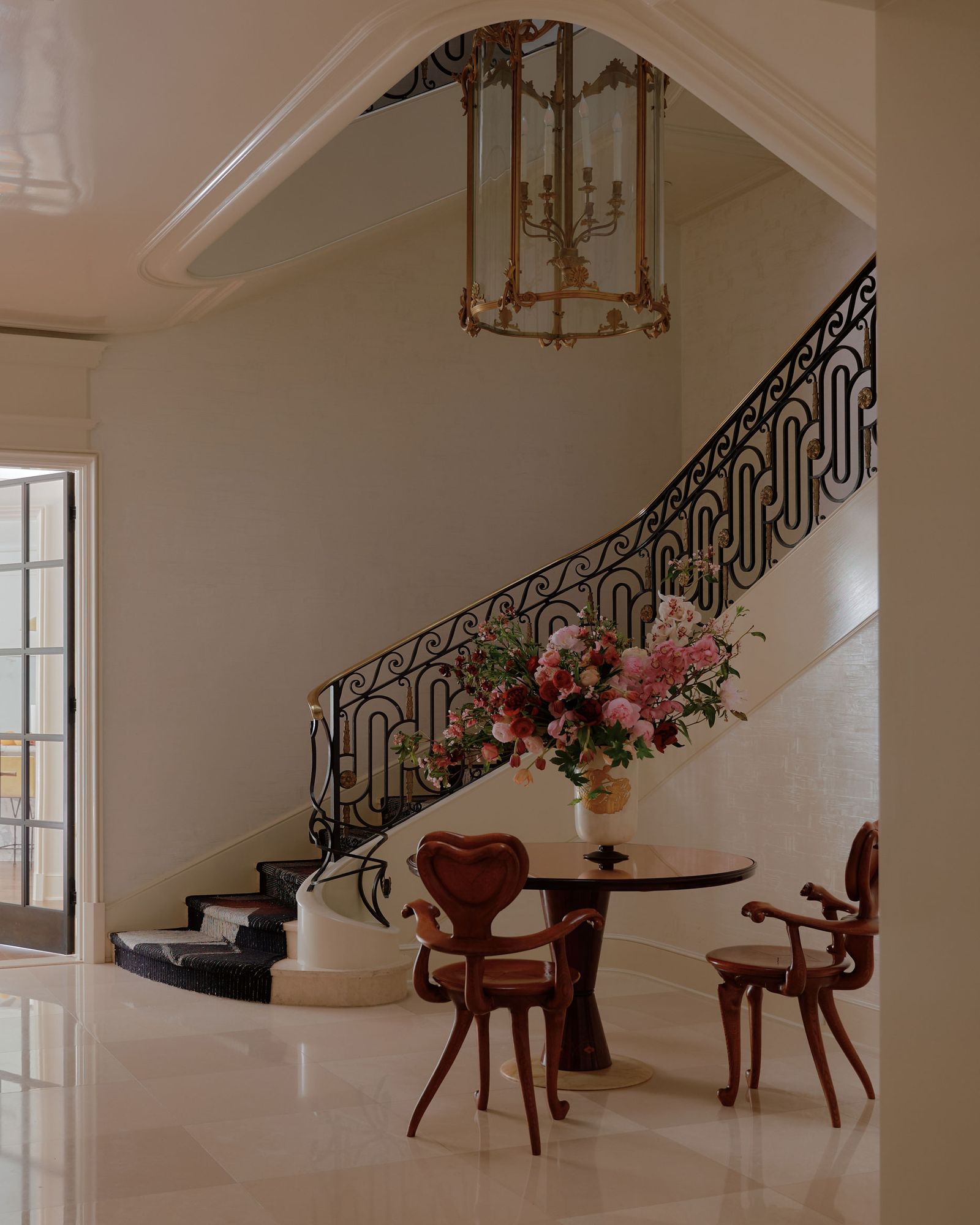 Rellano de escalera de casa adosada con mesa y sillas de madera