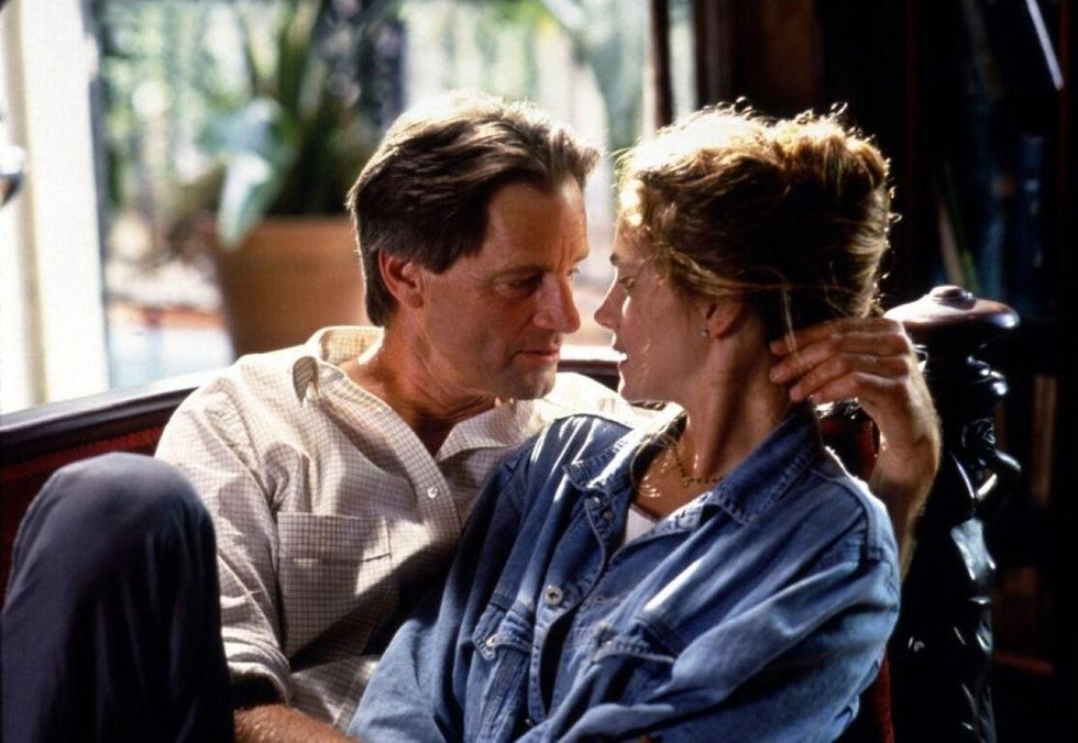 intimate moment between two individuals in a cozy setting