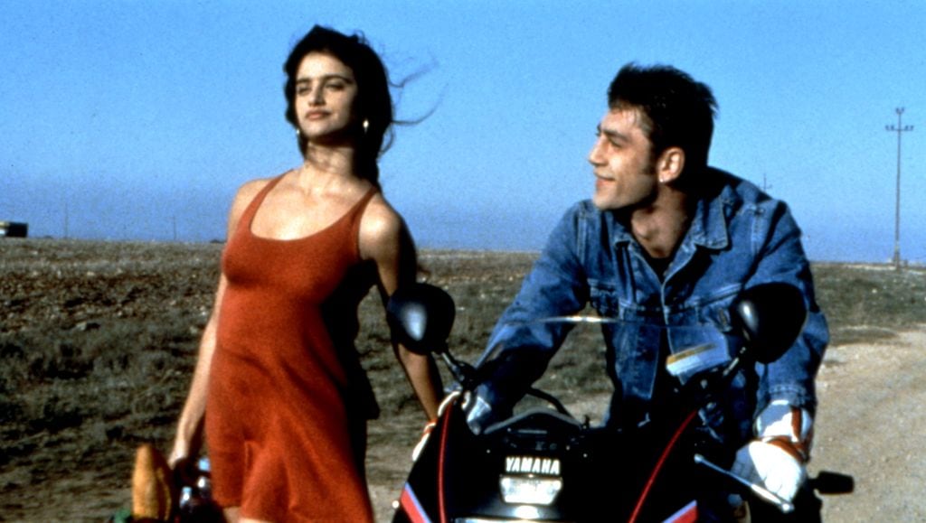JAMON, JAMON, Penelope Cruz, Javier Bardem, 1992. (c) Academy Entertainment/ Courtesy: Everett Collection.  1990s movies 1992 movies Bardem,javier Cruz,penelope Motorcycle Movies Red dress Sexy Walking 