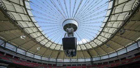 FILE - Stadium staff prepare temporary grass that was laid on top of artificial turf at BC Place stadium for an international friendly soccer match between MLS' Vancouver Whitecaps and League One's Wrexham in Vancouver, British Columbia, Friday, July 26, 2024. (Darryl Dyck/The Canadian Press via AP, File)