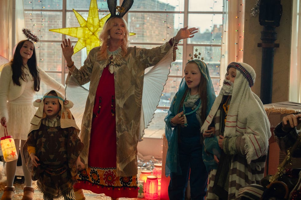 group of children and an adult in festive costumes celebrating a holiday event