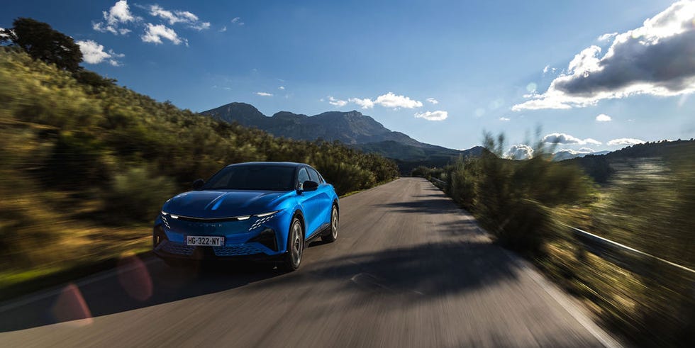 sport car driving on a winding road in a mountainous landscape