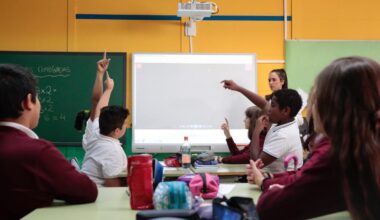 Estudiantes en clase preguntan a la profesora