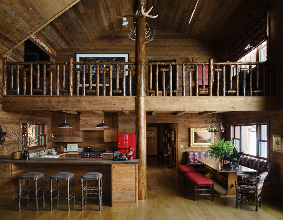 Rustic kitchen and dining area in a wooden cabin.