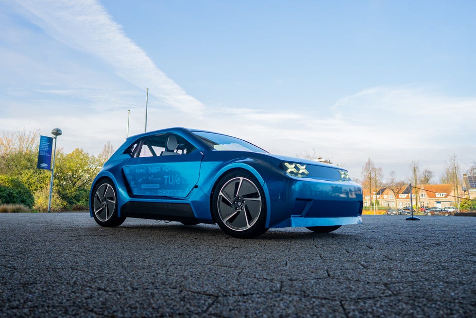 blue electric vehicle model displayed outdoors