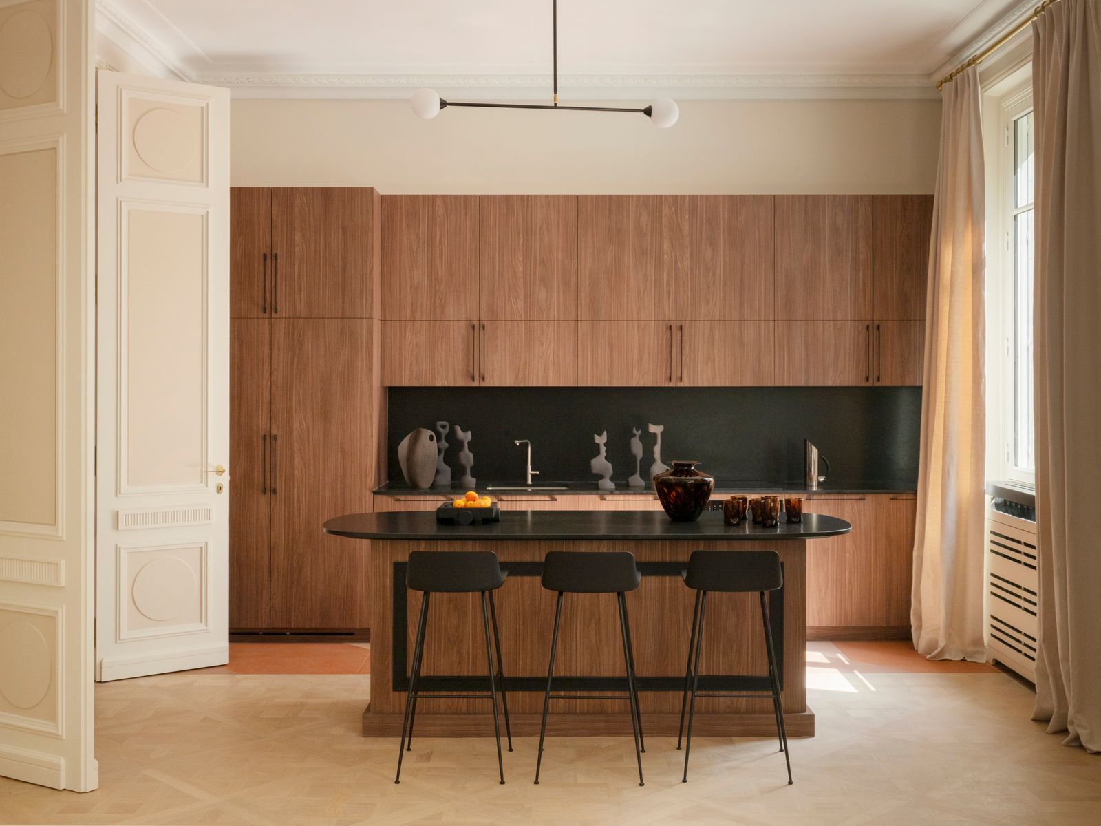 Cocina con alacena de madera y sillas de metal