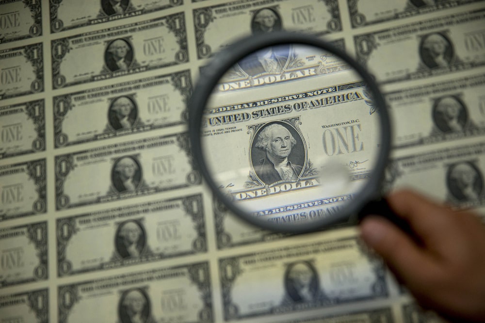 A magnifying glass is held over a 50 subject one dollar note sheet after being printed by an intaglio printing press in this arranged photograph at the U.S. Bureau of Engraving and Printing in Washington, D.C., U.S., on Tuesday, April 14, 2015. Republican efforts to pass a fiscal year 2016 budget cleared another hurdle as the House named its members to a conference committee and Senate Majority Leader Mitch McConnell pledged to do the same by the end of the week. Photographer: Andrew Harrer/Bloomberg