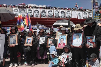 Familiares sostienen fotografías de sus