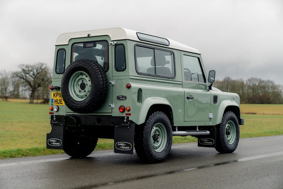 land rover defender parked on a road
