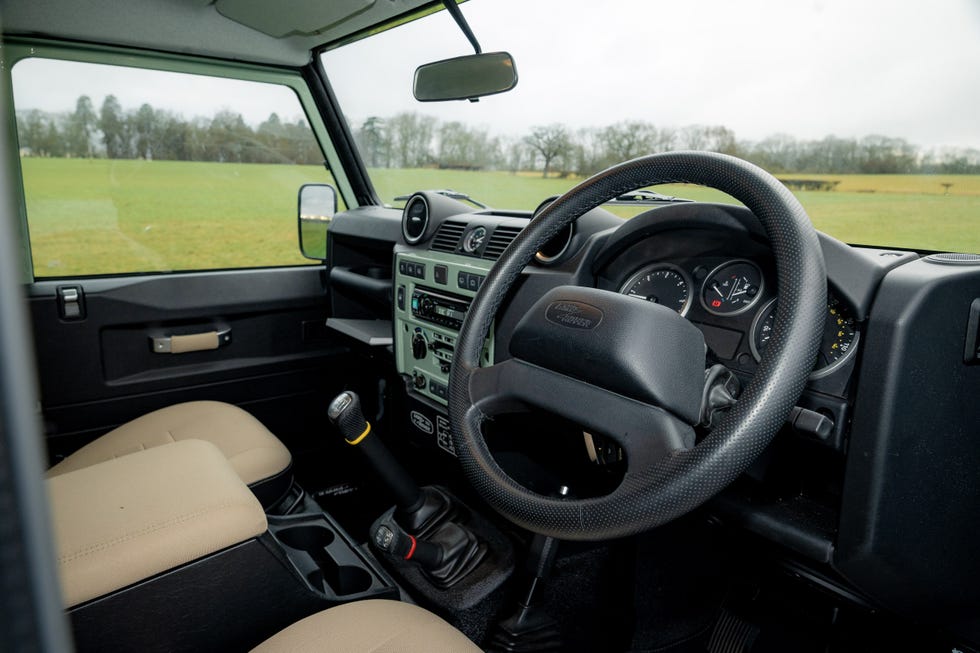 interior view of a vehicle showcasing the drivers seat and dashboard