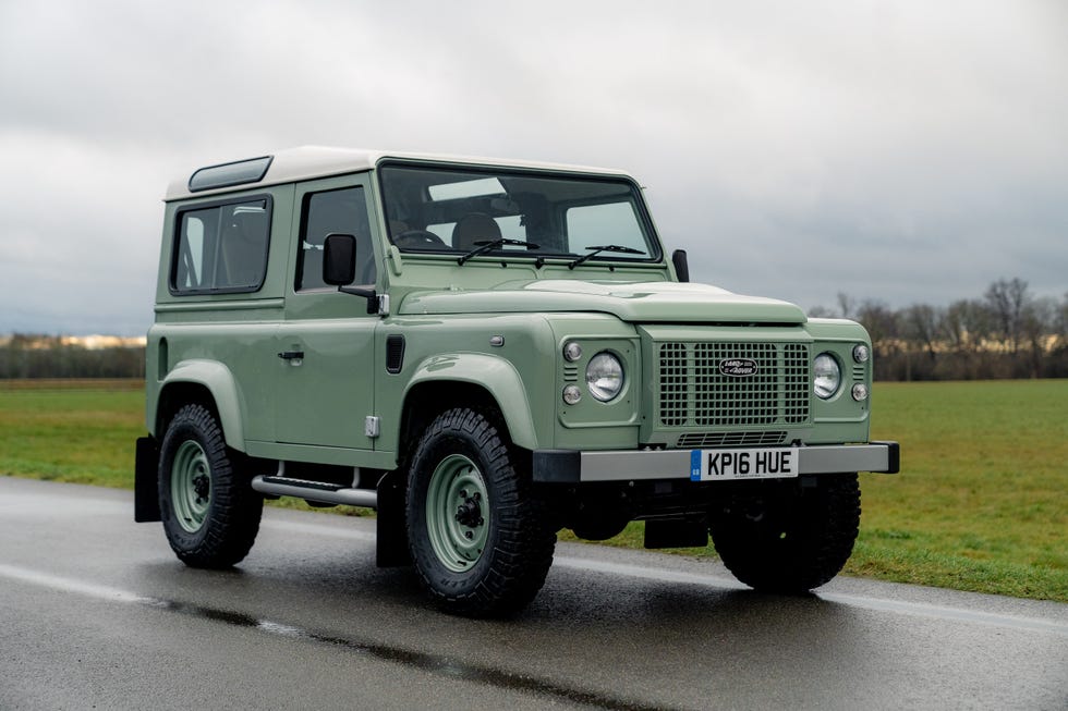 land rover defender parked on a road
