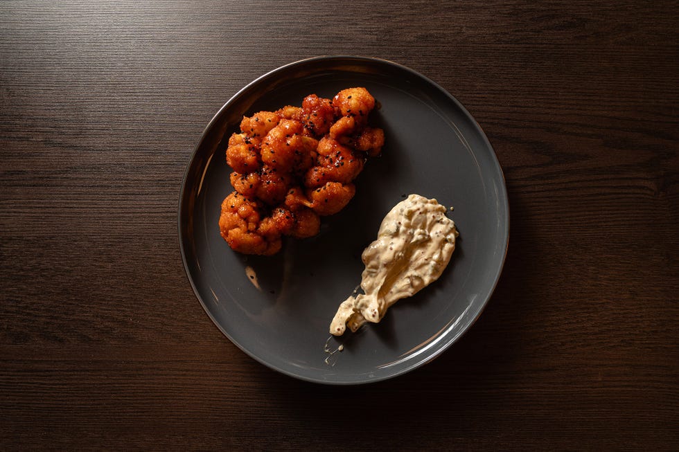 cauliflower dish with a creamy sauce on a gray plate
