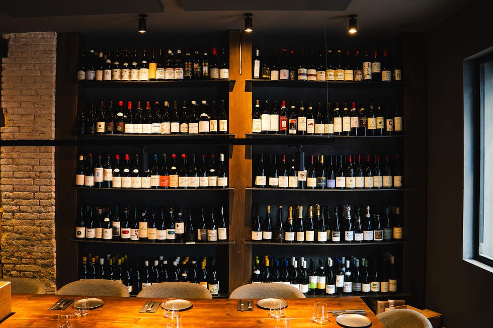 wine bottles displayed on shelves in a restaurant