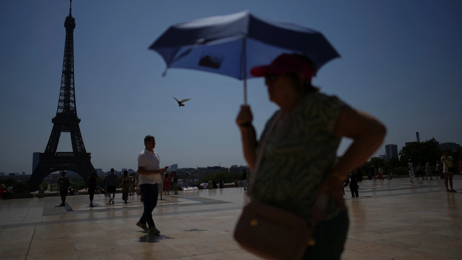 FILE - People walk at Trocadero plaza near the Eiffel Tower during a heat wave July 2, 2025, in Paris. (AP Photo/Christophe Ena, File)
Europe Heat Deaths