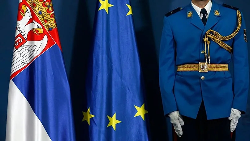A member of the Serbian honour guard stands by Serbia and EU flags during in Belgrade, Serbia, on 2 October, 2017.