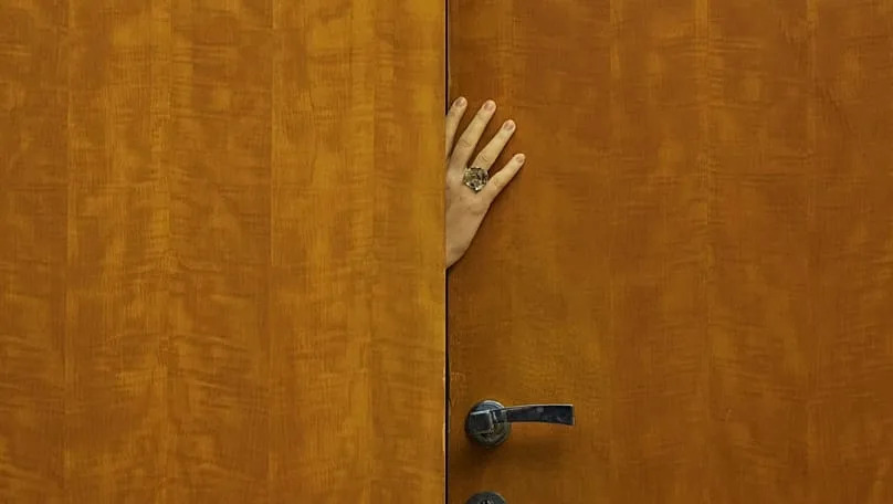 A staff member opens the door prior talks of European Commission President Ursula von der Leyen and Serbian President Aleksandar Vucic in Belgrade, Serbia, 15 October, 2025.