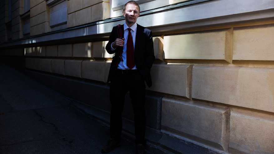 Matias Turkkila Senaatintorin liepeillä tummassa puvussa ja punaisessa kravatissaan.