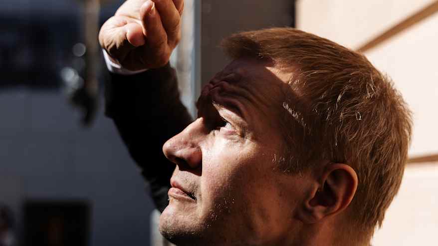 Matias Turkkila Senaatintorin liepeillä tummassa puvussa ja punaisessa kravatissaan.