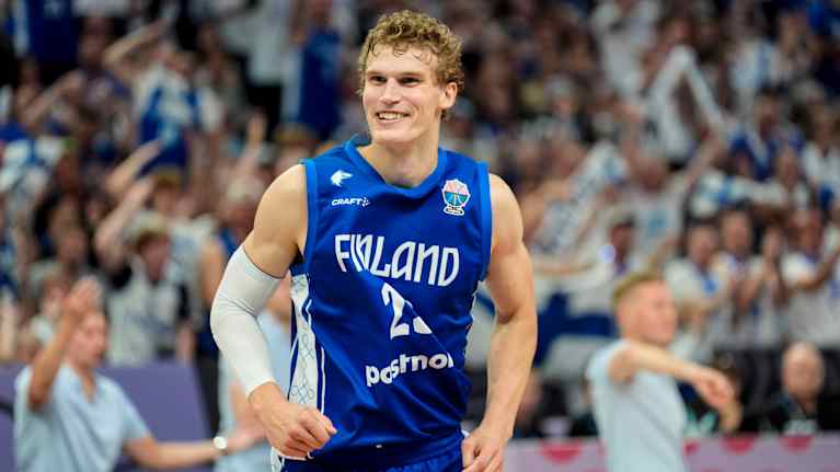 Lauri Markkanen hymyilee koripallokentällä.