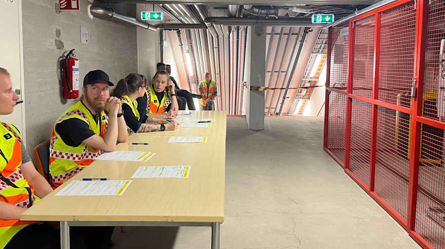 Pelastushenkilökuntaa pöytien ääressä 