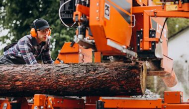 Carpenter working on a sawmill on a wood manufacture