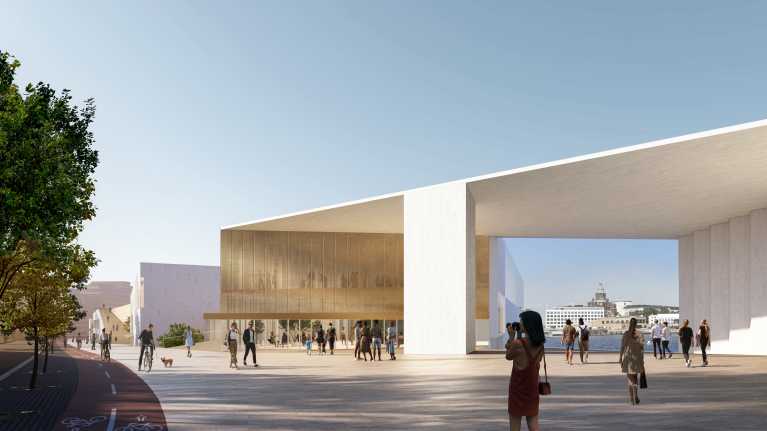 Vaalea katosmainen rakennus. Sen läpi näkyy Uspenskin katedraali.