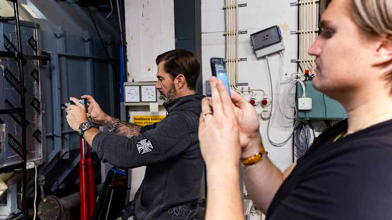 Janne Ahonen ja Elianin valmentaja Eero Blomqvist kuvaavat Eliania joka on tuulitunnelissa.